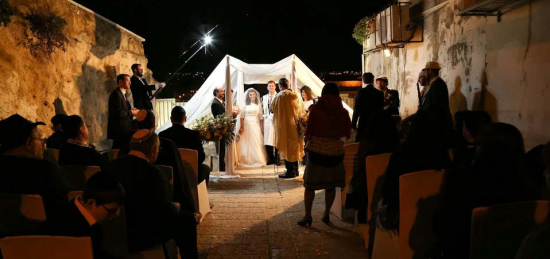 Bride and groom unite under the chupah