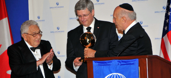 Prime Minister Stephen Harper accepts Appeal of Conscience Foundations World Statesman Award from founder/president Rabbi Arthur Schneier with Henry Kissingers hearty approval.